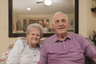 Older Caucasian couple smiling indoors