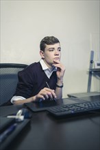 Caucasian teenage boy using computer
