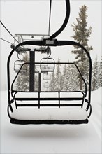 Empty ski lift on snowy mountainside