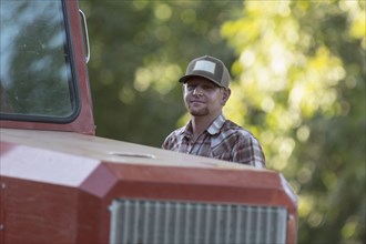 Portrait of Caucasian man near tractor