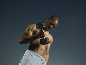 African American man lifting weights