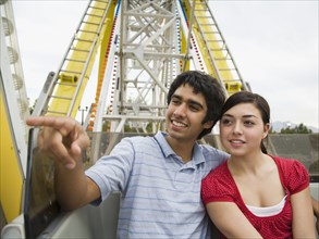 Multi-ethnic teenaged couple on carnival ride