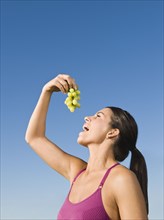 Native American eating grapes