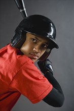 Mixed race baseball player ready to bat