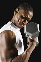 African man doing biceps curl with dumbbell