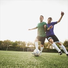 Men playing soccer on soccer field