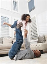 Father lifting daughter on his feet