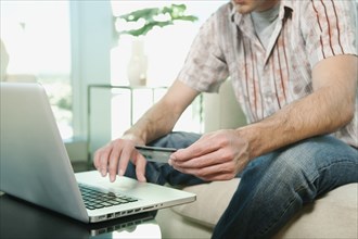 Caucasian man shopping online with credit card