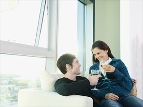 Couple sitting together and drinking wine