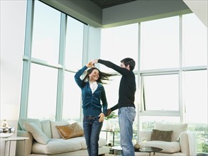 Couple dancing together in living room