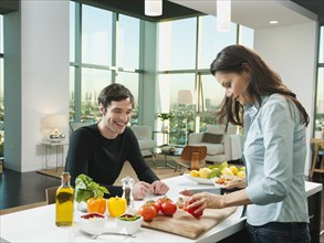 Couple making dinner together in kitchen