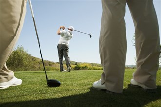 Men playing golf together on golf course