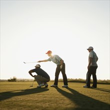 Men playing golf together on golf course
