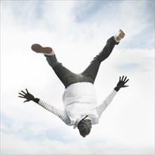 African American man upside-down in the air