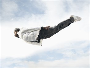 African American man flying through mid-air