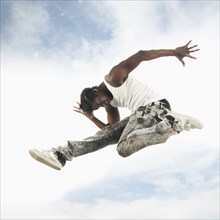 African American man jumping in mid-air