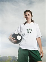 Caucasian soccer player holding ball