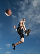 Caucasian man playing basketball
