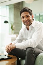 Smiling mixed race businessman in lobby