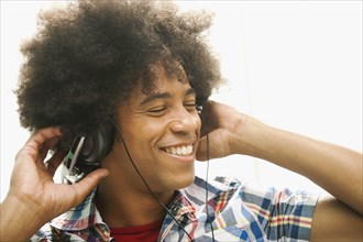 Black man listening to music with headphones