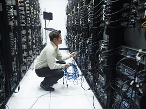 Asian businessman working in server room