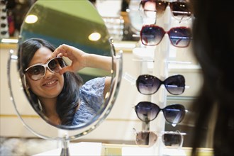 Mixed race woman shopping for sunglasses