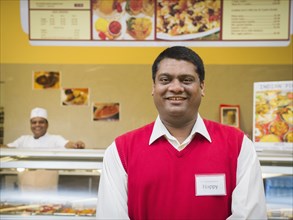 Businessman smiling by restaurant counter
