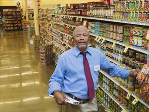 African American businessman smiling in grocery store