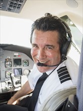 Caucasian pilot in airplane cockpit