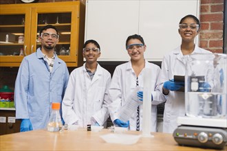 Teacher and students smiling in science lab