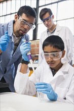 Teacher and students working in science lab