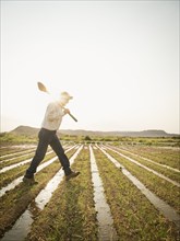 Caucasian farmer walking in crop field