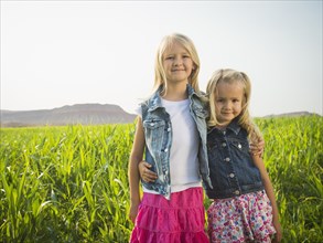 Caucasian girls smiling in corn field