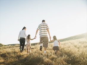 Family walking together in rural field