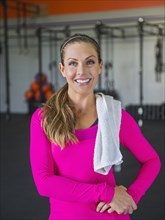 Caucasian woman smiling in gym