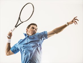 Caucasian man playing tennis