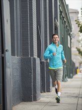 Caucasian man running on city street