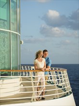 Caucasian couple admiring view from boat deck