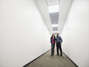 Business people talking in office corridor