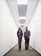 Business people talking in office corridor