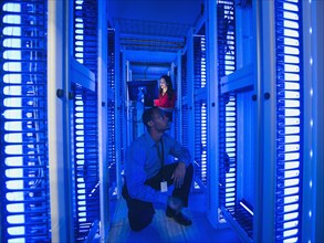 Business people working in server room