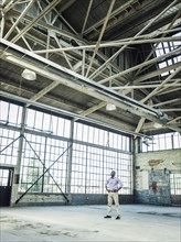 Black businessman standing in empty warehouse