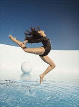 Caucasian woman dancing on water surface