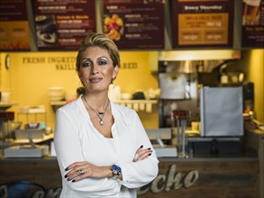 Hispanic woman smiling in cafe