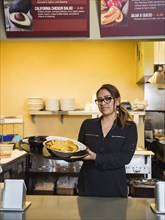 Hispanic woman working in cafe