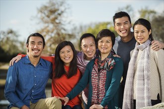 Chinese family smiling outdoors