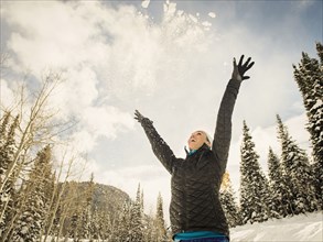 Low angle view of Caucasian woman playing in snow