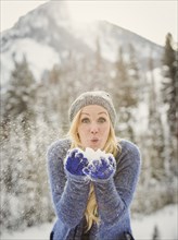Caucasian woman playing in snow