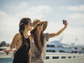 Caucasian women posing for cell phone selfie