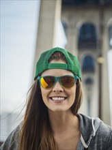 Smiling Caucasian woman posing under overpass
